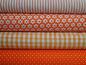 Preview: Verschiedene Baumwollstoffe in orange.